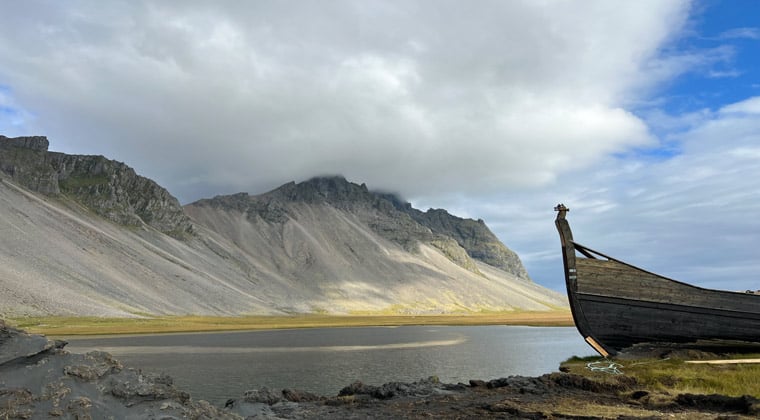 Boot am Ufer des Stokksnes Strand und im Hintergrund der Berg Vestrahorn.