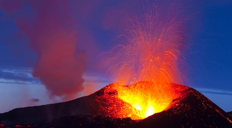 Blick auf einen glühenden, Lava sprühenden Vulkan in Island